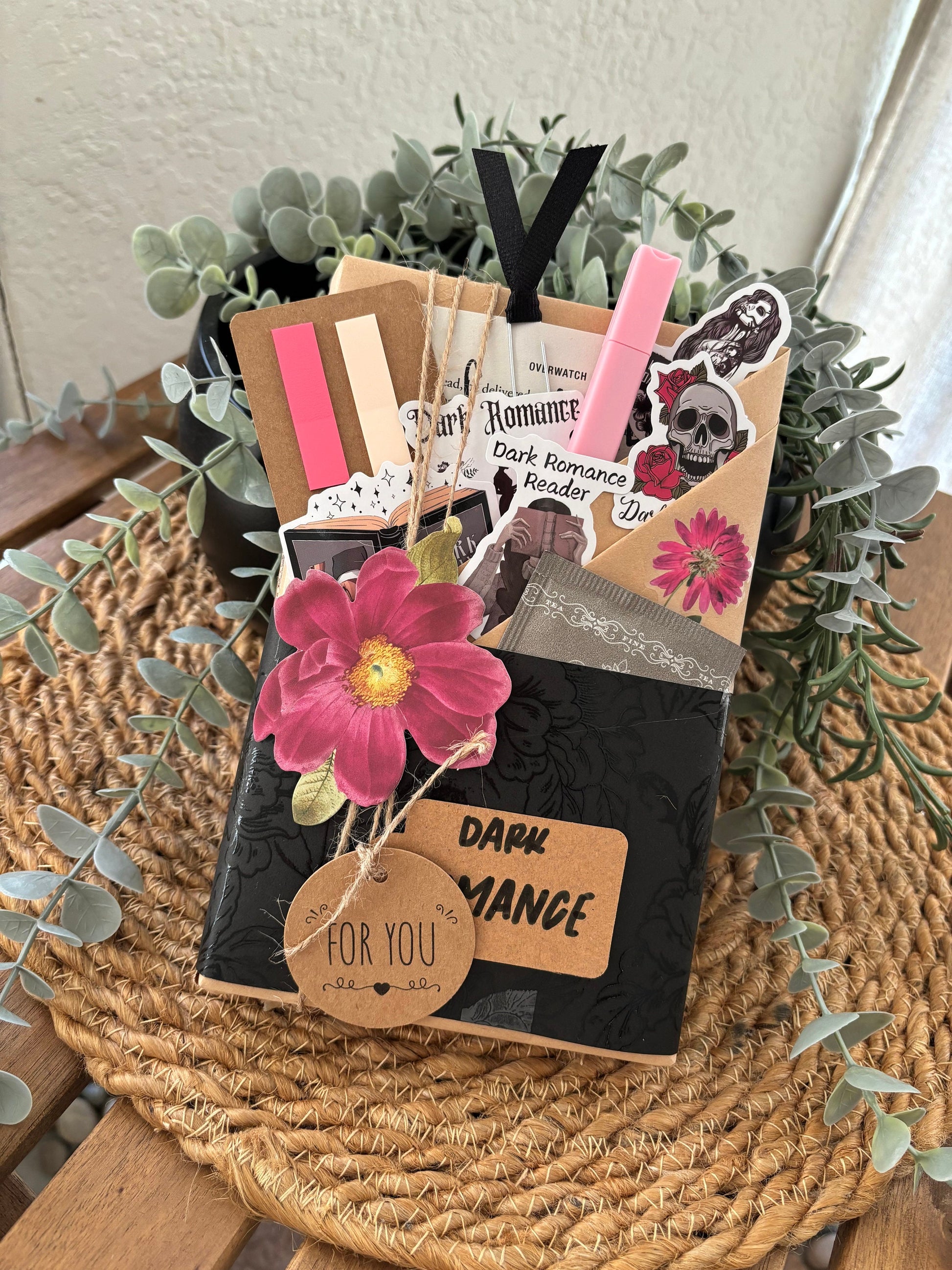 this dark romance book gift is part of a blind book dates collection made for spice-loving bookworms. Includes a blind book, reading log, smut stickers, tea, and annotation tools inside a surprise box. Whether for yourself or a loved one, this custom book box is perfect for romantasy merch fans or mystery box vintage lovers. Makes a great gift for book lover friends or readers in the mood for a spicy, cozy, hygge gift box treat.