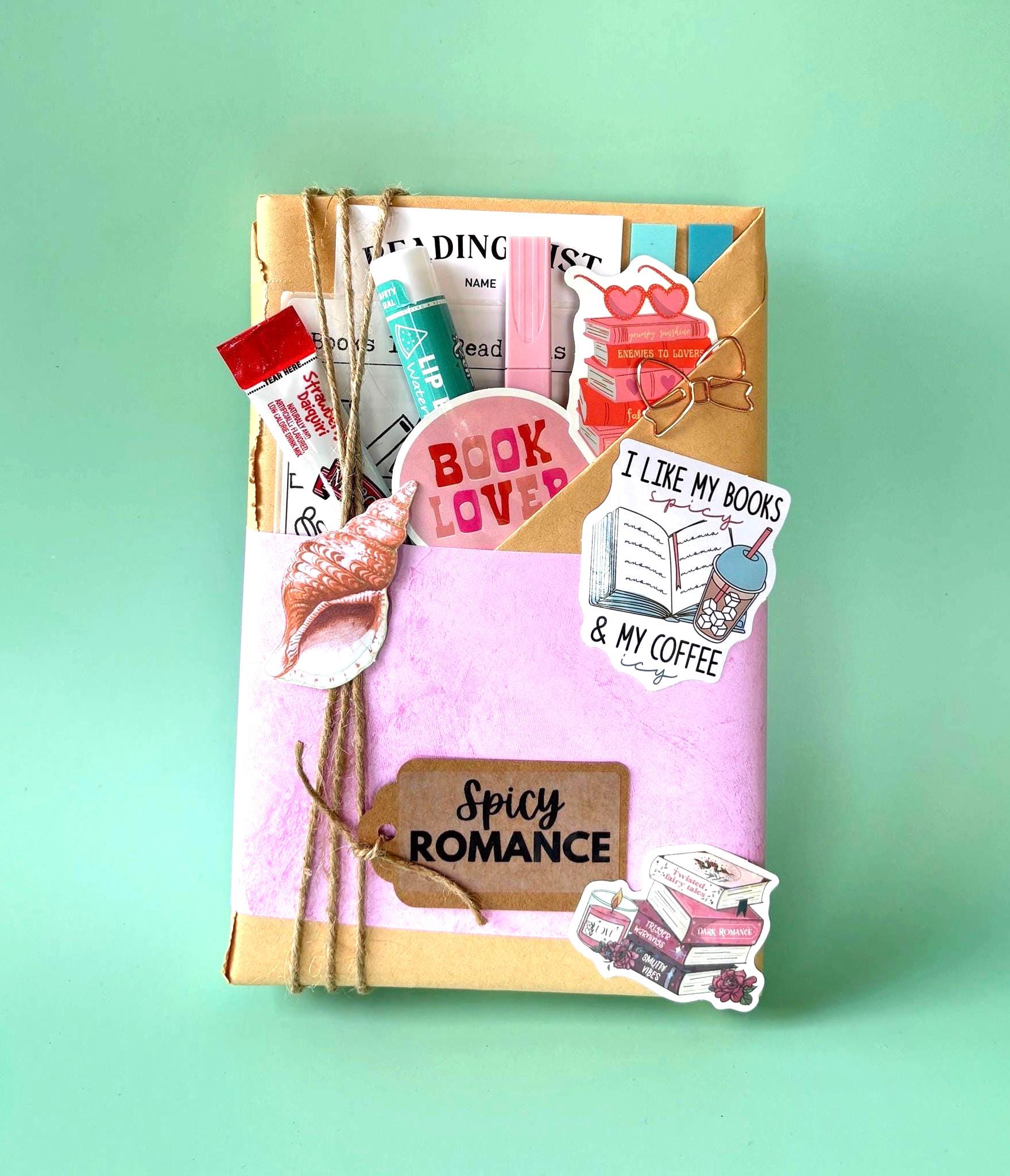 Blind Date with a Book Mystery Book  Summer-ready blind date with book gift box tucked in a reusable beach bag tote. Includes a blind book, cozy book accessories like reading log, smut stickers, tea, and a fantasy bookmark. Ideal surprise box for romantasy fans, Kindle Paperwhite beach readers, or booktrovert shirt wearers looking for a summer treat yourself moment. Also works great as a mystery box gift, wife gift box, or spicy smut box for those into dark romance books and wingspan goodies.