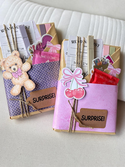 Blind Date with a Book mystery box for readers includes a surprise book in genres like romance, thriller, sci-fi, or fantasy, wrapped with blind date-style clues. Also included are herbal tea, annotation tabs, a highlighter, bookish stickers, book tracker, and a library-style reading list. Perfect for fans of booktok, romantic, spicy, or dark romance books, and anyone looking for a fun surprise gift for book lovers.