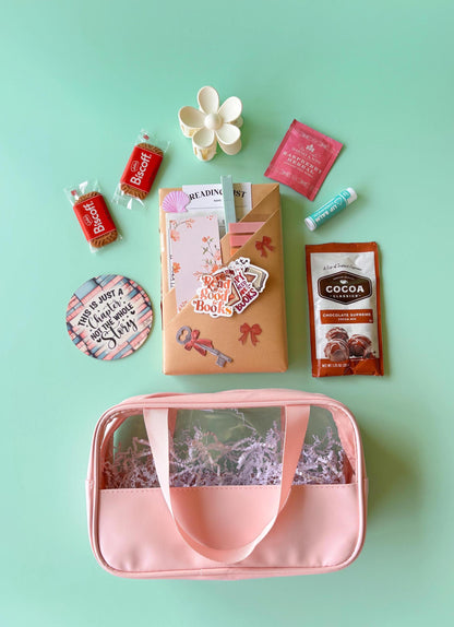 Blind date with a book beach bag includes a mystery book wrapped in kraft paper, packed in a water-resistant tote with tea, cookies, reading log, annotation tabs, smut stickers, and book accessories. This summer surprise box is perfect as a gift for book lover friends, a bookstagram photo op, or a treat yourself moment. Great for fantasy fans, romantasy merch collectors, mystery book club readers, or Kindle Paperwhite beachside binge readers.