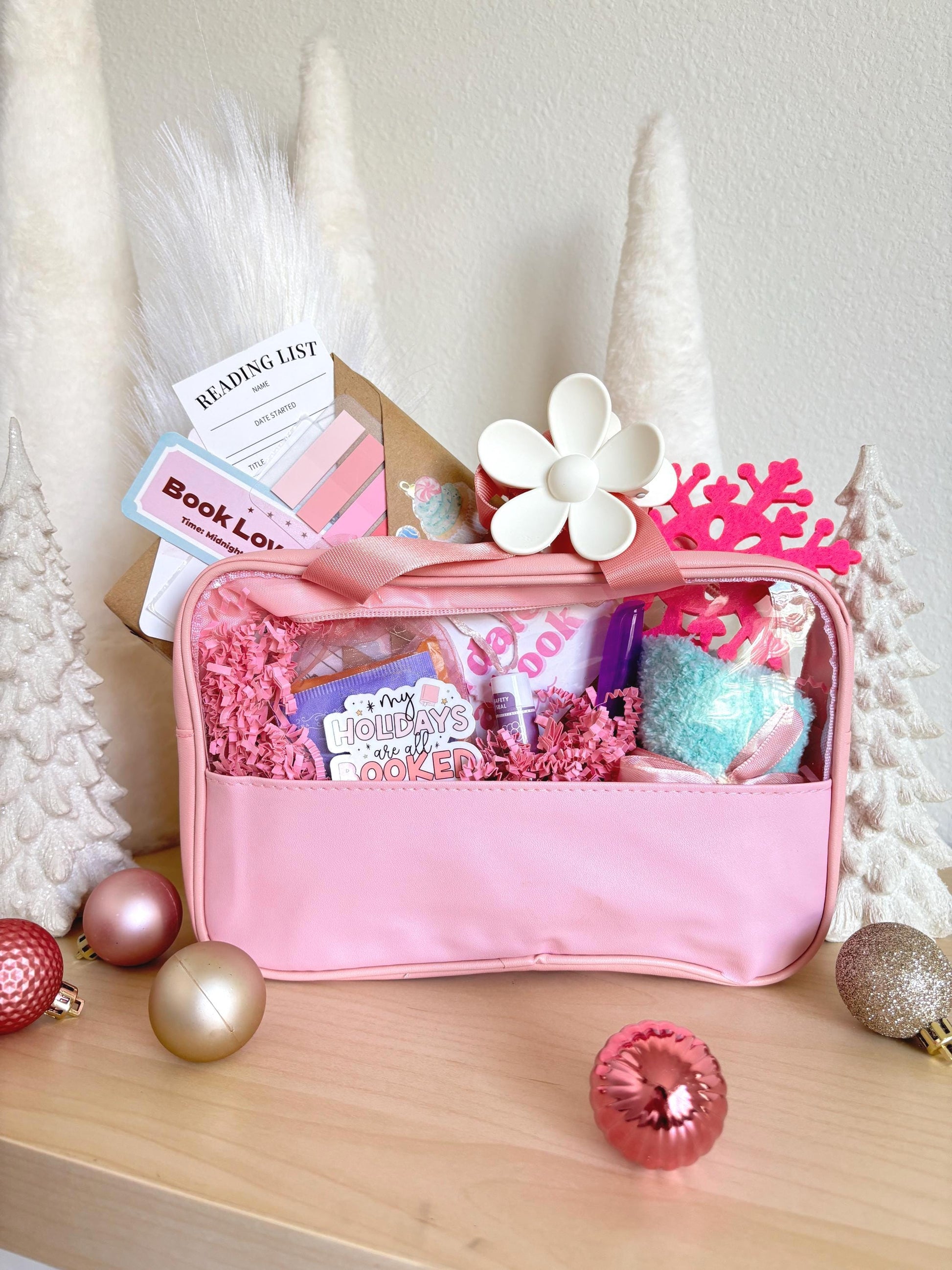 A romantic blind date with a book box in dreamy pink tones, perfect for dark romance or smut lovers. This christmas blind date with a book features a surprise novel, cocoa, cozy socks, and tea for the ultimate winter reading gift.