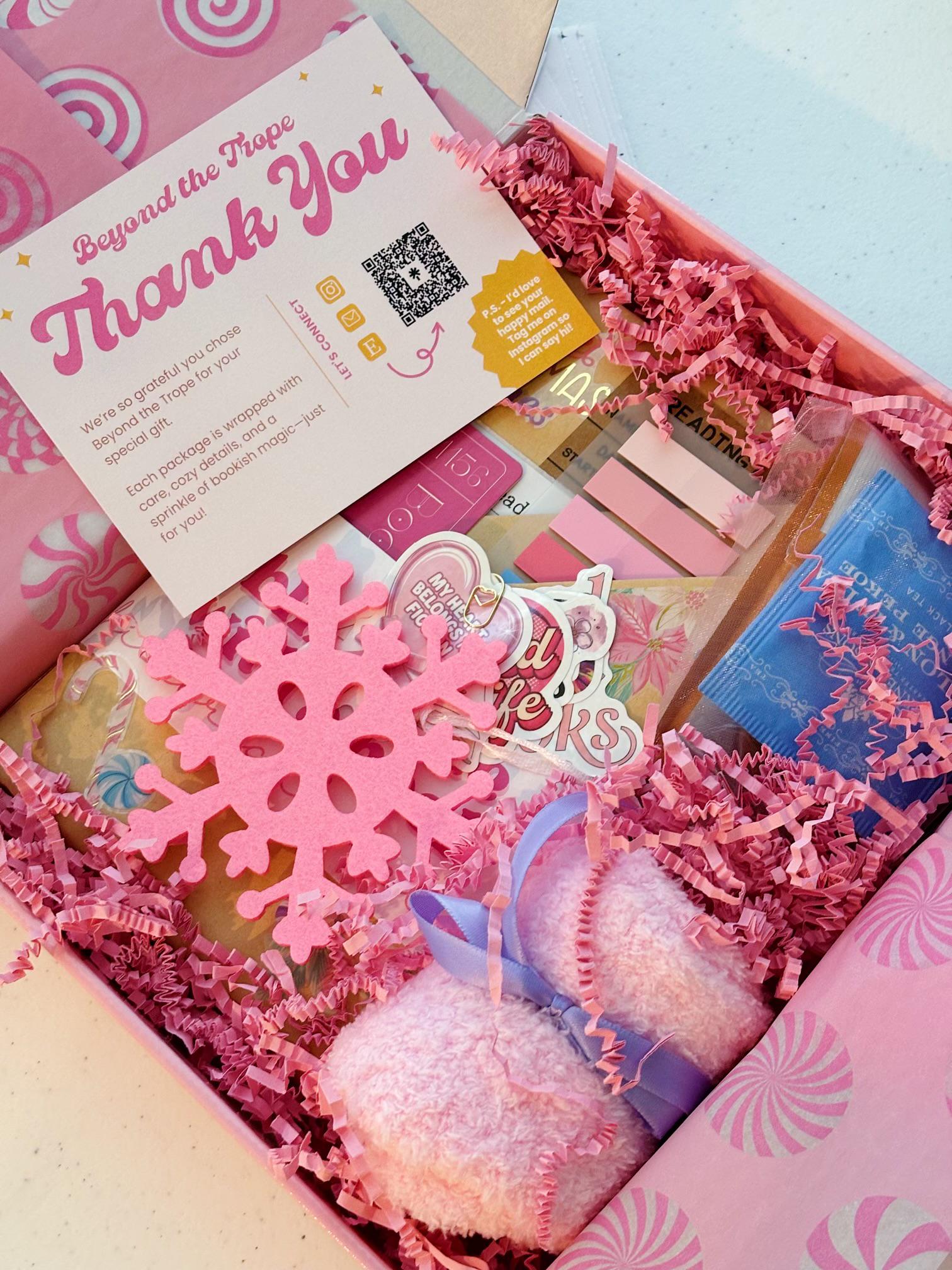 Photo of a dreamy Pink Christmas blind date with a book gift with soft pink tones, bookish stickers, and cocoa. The perfect blind date with a book box for readers who love blind date with a book dark romance and cozy holiday gifting.