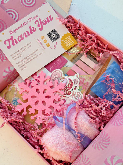 Photo of a dreamy Pink Christmas blind date with a book gift with soft pink tones, bookish stickers, and cocoa. The perfect blind date with a book box for readers who love blind date with a book dark romance and cozy holiday gifting.